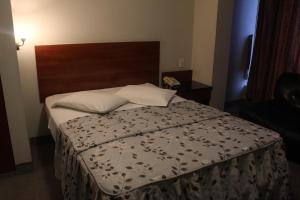 Postel nebo postele na pokoji v ubytování Hostal Bond