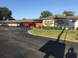 a shadow of a person walking in front of a building at Cooper Motel Tuscola in Tuscola