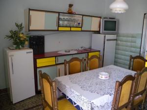 a small kitchen with a table and a refrigerator at Apartment Fazana, Istria 13 in Fažana