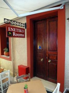 a wooden door to a room with a sign on it at Enetiko Rooms in Chania Town