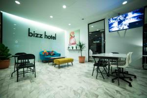 a bixa hotel lobby with a table and chairs at bizz hotel in Puchong