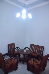 a dining room with a table and chairs and a light at Banyu Homestay in Banyuwangi