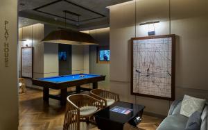 a game room with a pool table and a couch at The Den, Bengaluru in Bangalore