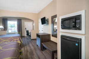 a hotel room with a bed and a flat screen tv at Super 8 by Wyndham Murfreesboro in Murfreesboro