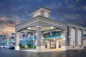 a large building with a tower on top of it at Super 8 by Wyndham Murfreesboro in Murfreesboro