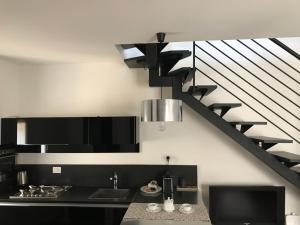 a kitchen with a sink and a staircase at Modena Charme in Modena