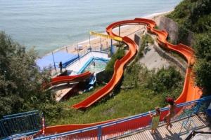 a water slide on the side of a beach at Sani Family Hotel in Byala