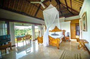a bedroom with a bed with a mosquito net at Amori Villas in Ubud