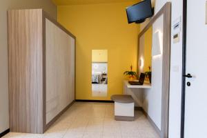 a hallway with a yellow wall and a door at Hotel Continental in Tortoreto Lido