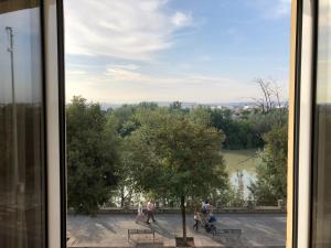 a view from a window of people walking around a park at Tu Casa En El Rio in Córdoba