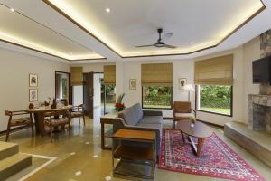 a living room with a couch and a table at The Riverview Retreat Corbett by Leisure Hotels in Garjia