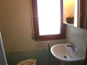 a bathroom with a sink and a mirror at Capri in Bibione +21 photos