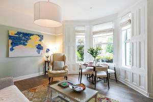 a living room with a table and chairs at Cyprus View Apartment in Belfast