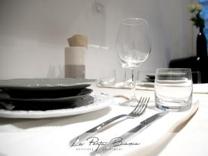 a table with a plate and a glass of water at La Porta Bianca in Trieste