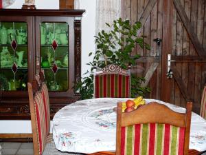 a dining room with a table with a bowl of fruit on it at chambre chez sylvie in Haux