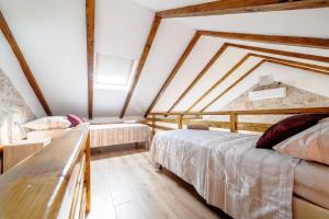 a attic bedroom with two beds and a couch at Falcons Nest in Šibenik