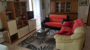 ein Wohnzimmer mit einem Sofa und einem Stuhl in der Unterkunft Apartment Valpolicella in Marano di Valpolicella