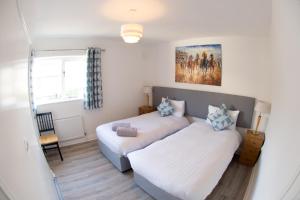 a bedroom with two beds and a window at Liberty Townhouses in Dublin