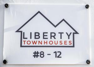 a sign that reads liberty town houses with a arrow at Liberty Townhouses in Dublin