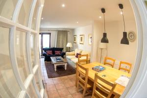 a living room with a table and a dining room at Liberty Townhouses in Dublin
