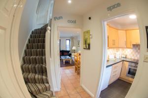 a staircase leading to a kitchen and a living room at Liberty Townhouses in Dublin