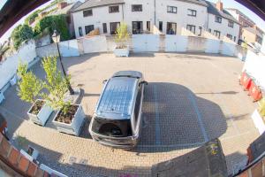 a car is parked in a parking lot at Liberty Townhouses in Dublin