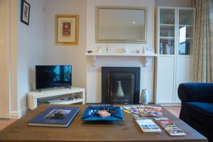 a living room with a coffee table and a fireplace at Liberty Townhouses in Dublin