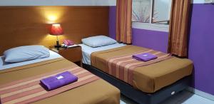 Ένα ή περισσότερα κρεβάτια σε δωμάτιο στο Hotel Dequr Jakarta Kota