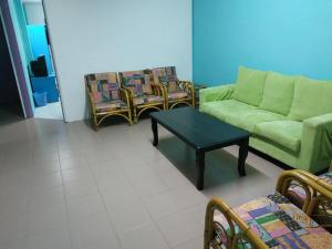 a living room with a couch and chairs and a table at Formosa Hotel in Malacca