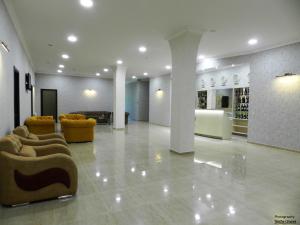 a lobby with couches and chairs in a building at Resort Martvili in Martvili