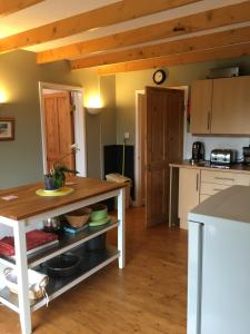 a kitchen with a wooden table in a room at The Granary Country Retreat in Lampeter