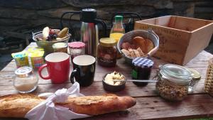 a wooden table with bread and other food items on it at La Cabane Aux Loups in Crépy-en-Valois