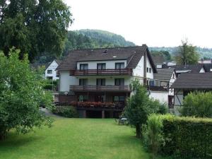 a large house with a lawn in front of it at Bed&Breakfast Eifelpension Brückenschenke in Fuchshofen