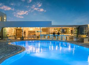 a large blue swimming pool in front of a building at A Hotel Mykonos in Mikonos