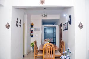 a dining room with a table and chairs at Sri Vana Durga Service Apartment in Sringeri