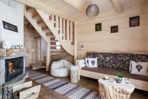 a living room with a couch and a fireplace at Chata Przy Dolinie z sauną in Kościelisko