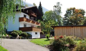 a house with a fence next to a driveway at Haus Tisch in Schruns-Tschagguns