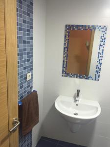 a bathroom with a sink and a mirror at Porto de Espasante -Severino Blanco in O Porto de Espasante +21 photos