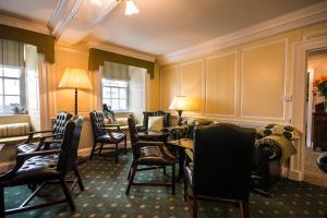 a waiting room with chairs and a table and a couch at Bishopsgate House Hotel in Beaumaris