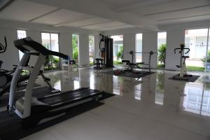a gym with several tread machines in a room at At Sea Condo in Klong Muang Beach