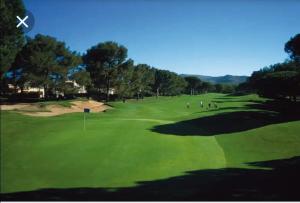 a group of people playing golf on a golf course at Appartement à Cap Estérel Village Pierre et Vacances Piscines et parking inclus in Agay - Saint Raphael