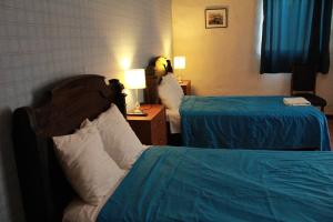 Postel nebo postele na pokoji v ubytování Hotel Náutico de Paita