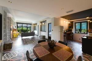 a kitchen and living room with a table and chairs at Appart'hotel Fior Di Ribba in Sartène