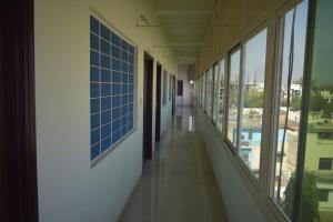 an empty corridor of a building with windows at Hotel Ramnivas in Udaipur