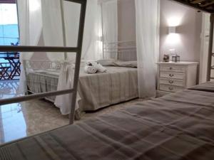 a bedroom with two beds and a dresser at Palazzo Mosca in Sannicola