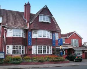 a large red brick house with blue signs on it at The Royal Bridlington in Bridlington