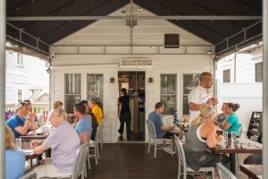 a group of people sitting at tables in a restaurant at 8 Dyer Hotel in Provincetown