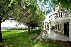 a house with a patio with a view of the ocean at Apartments Bella Vista in Umag