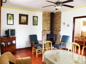 a living room with a glass table and chairs at Rural El Puerto Mayordomo in Ardales