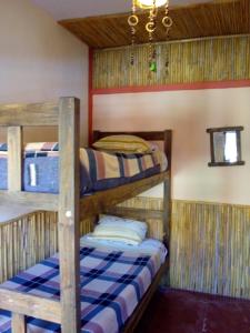a bunk bed room with two bunk beds in it at Tilcara Mistica Hostel in Tilcara